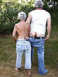 Busty granny in jeans shows off her body